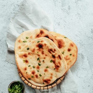 naan flatbreads on gray cement, copyspace vertical